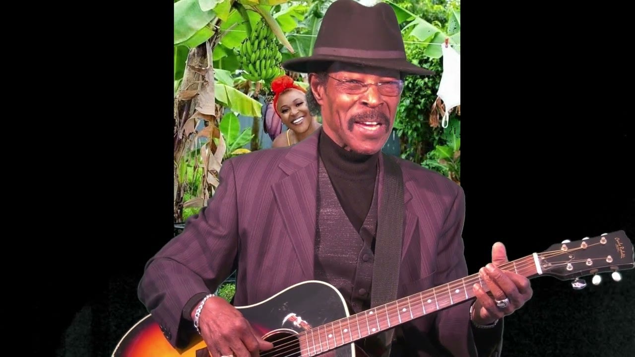 Still from Haiti by RP Video Pro with Roman Paul in a fedora and guitar